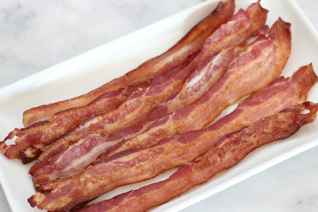 Once you use this method to bake your bacon, you'll never prepare it another way again! Easy perfect oven baked bacon! #cookingbasics #bacon #lowcarb #keto