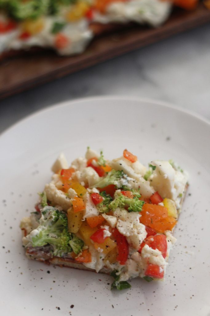 Looking for a yummy but low carb appetizer? Look no further! This low carb cold veggie pizza recipe is a healthier take on a traditional carb laden recipe! #lowcarb #keto #vegetables #fathead #lowcarbappetizer #cauliflower #broccoli #bellpeppers #ranch low carb cold veggie ranch pizza