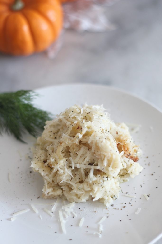 This low carb baked garlic parmesan cauliflower mash is a perfect side dish for Thanksgiving or any meal. #lowcarb #keto #LowcarbThanksgiving #ketothanksgiving #mashedcauliflower