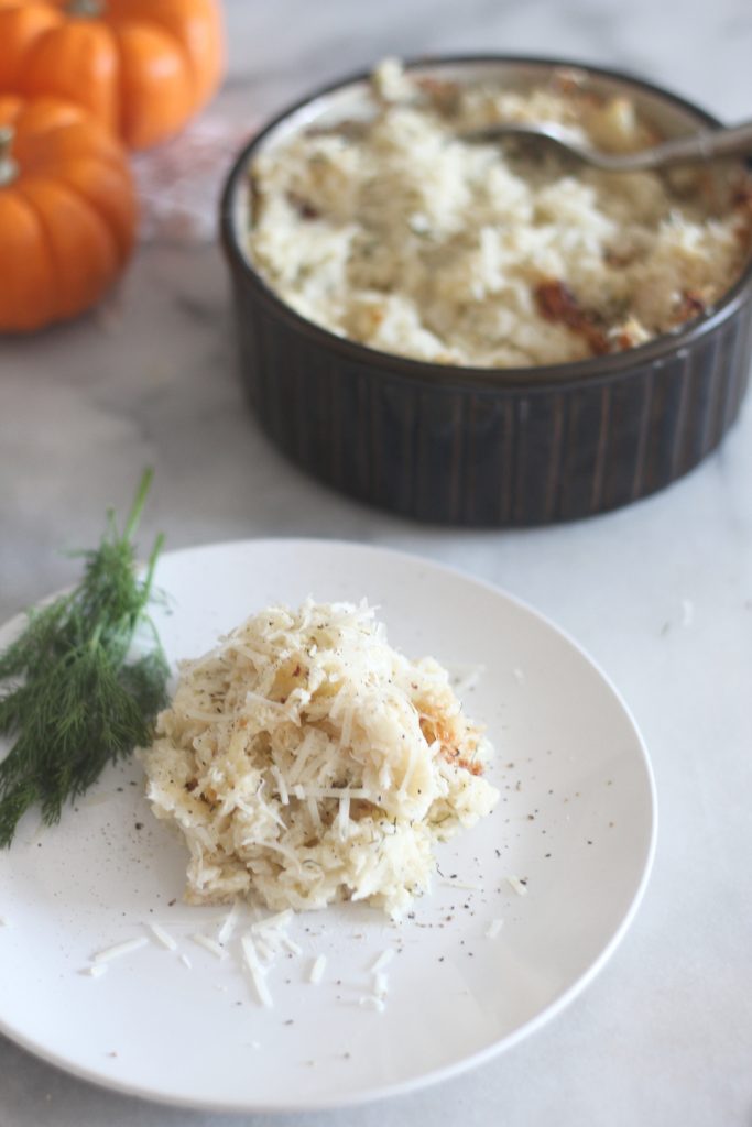 This low carb baked garlic parmesan cauliflower mash is a perfect side dish for Thanksgiving or any meal. #lowcarb #keto #LowcarbThanksgiving #ketothanksgiving #mashedcauliflower