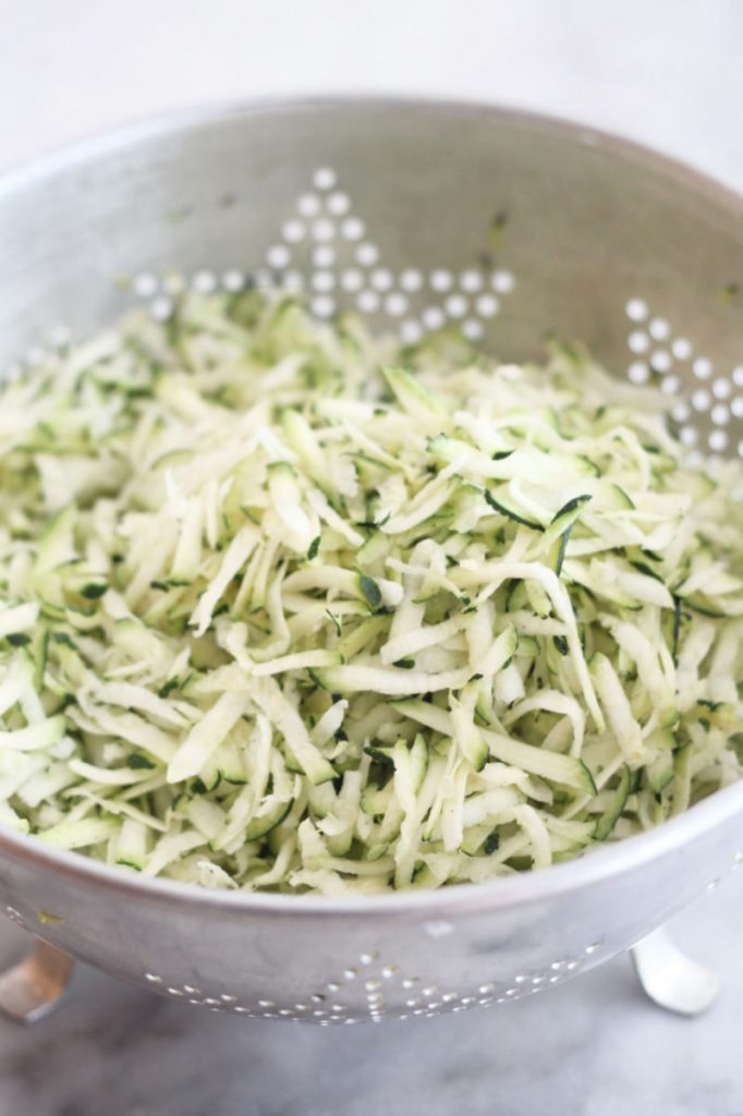 shredded zucchini in a colander