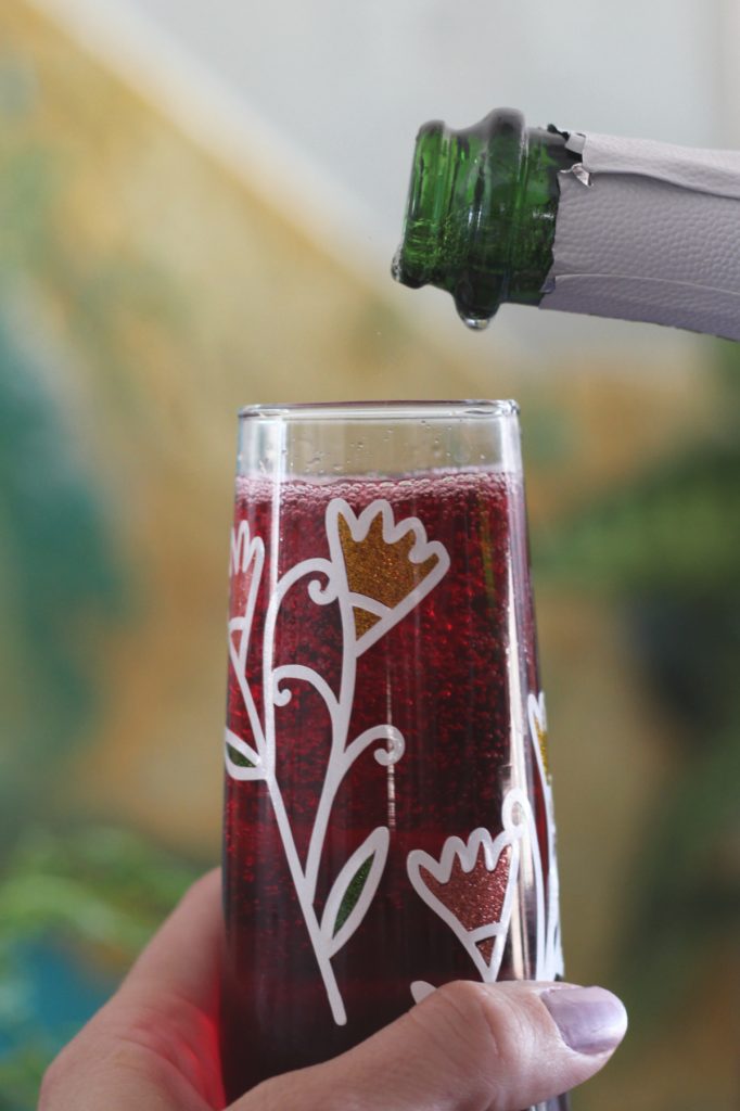Sparkling wine pouring into glass with tea and Sugar Free Torani Lime Syrup.