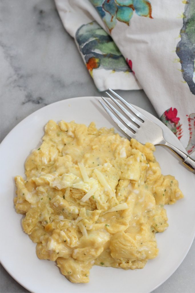 Herbed white cheddar scrambled eggs on a plate.